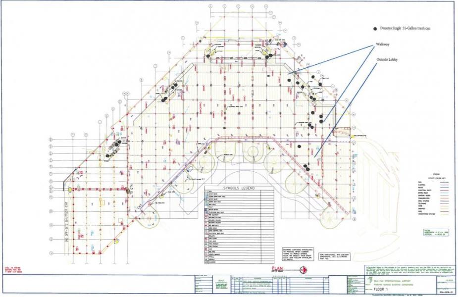 “Architectural floor plan of a building’s first level showing rooms, walls, structural gridlines, utilities, and a symbols legend, including labeled walkways, lobby areas, and marked locations.