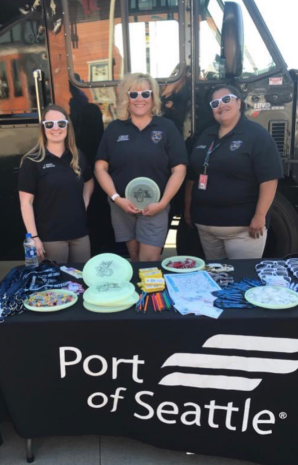 Three operators representing Port of Seattle at an event table.