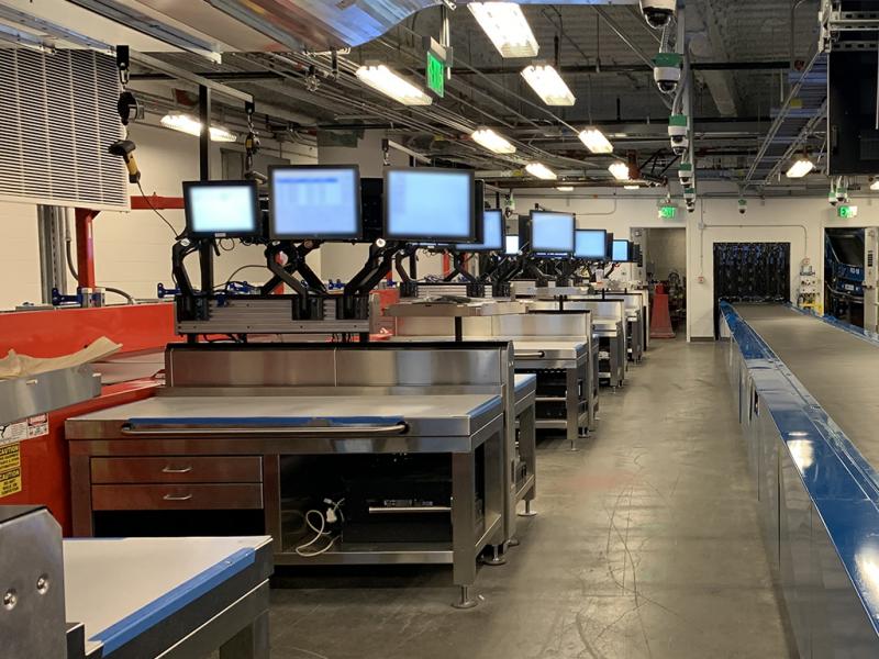 Ergonomic workstations allow for bags requiring manual screening to be moved without lifting.