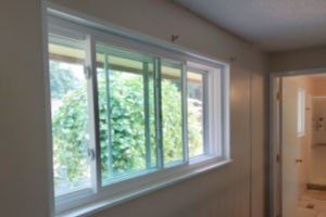 Indoor view of a sliding window that has received sound-proofing barriers.