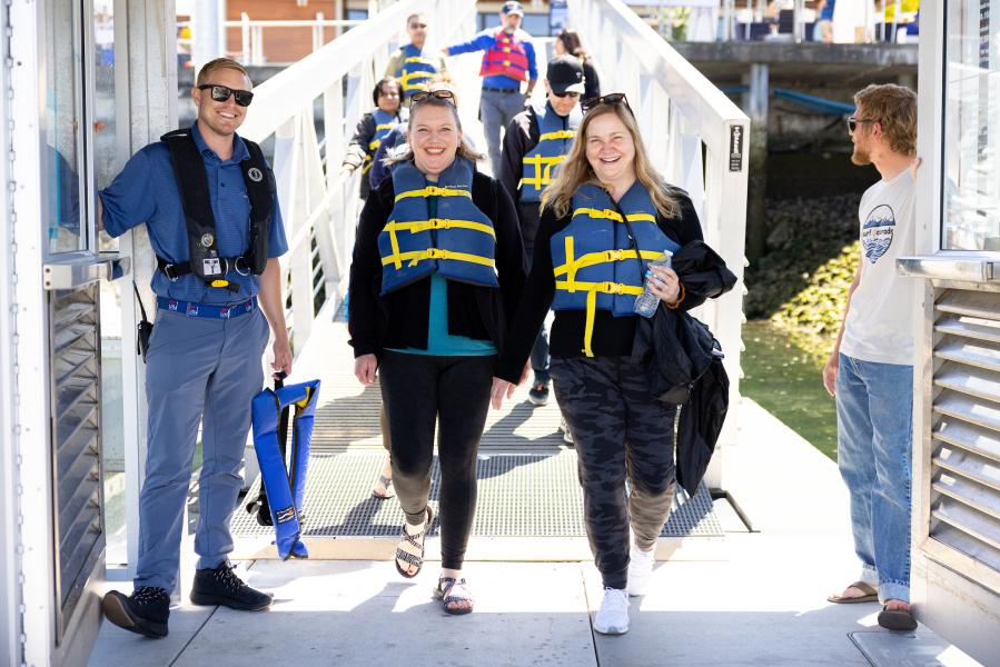 Sailors walking down I dock at Shilshole Bay Marina.