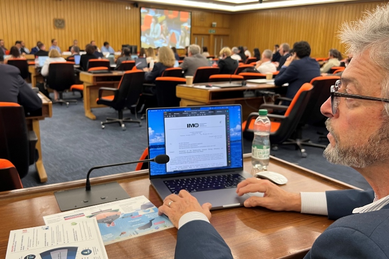 Felleman takes notes on a laptop at a large meeting.
