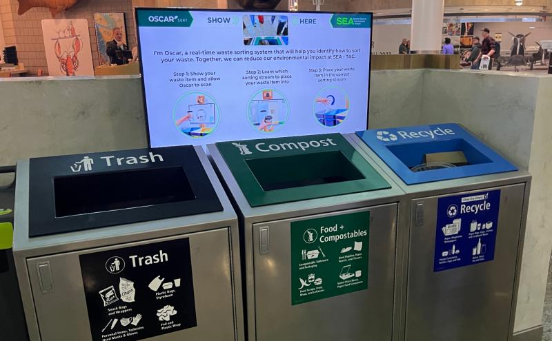 Oscar AI screen above trash, food compostables, and recycling bins.