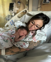 Baby lays on mother's chest.