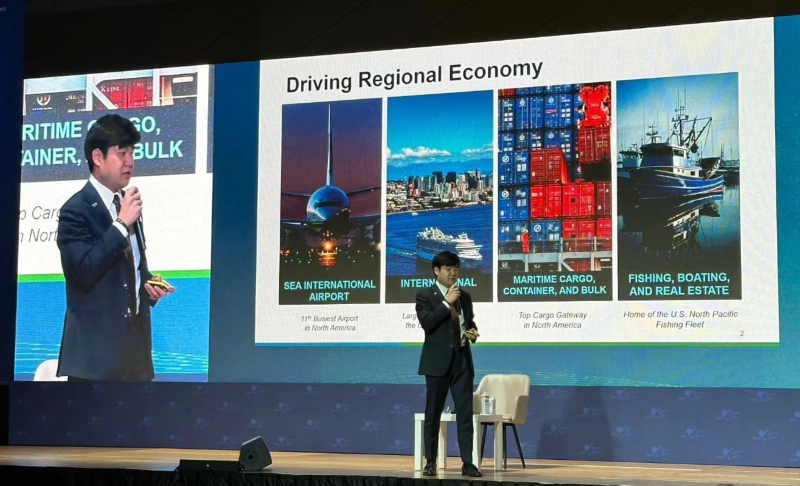 Cho presenting on a large stage driving regional economy.