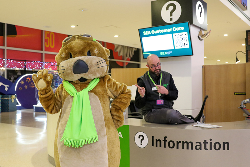 Jett visiting a SEA information desk and receptionist.