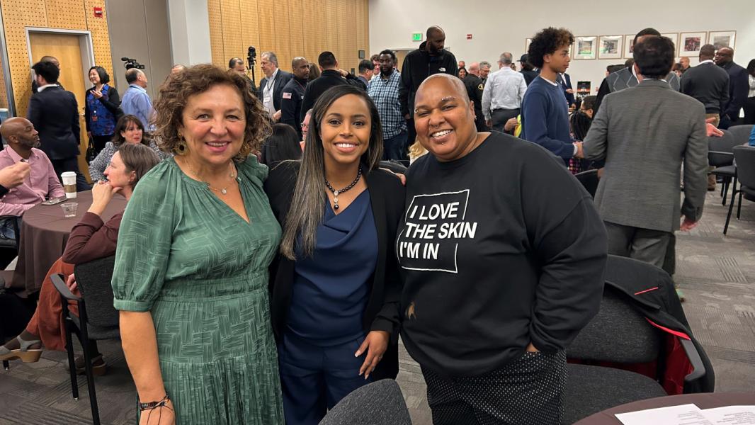 Mohamed with two women at a professional conference.