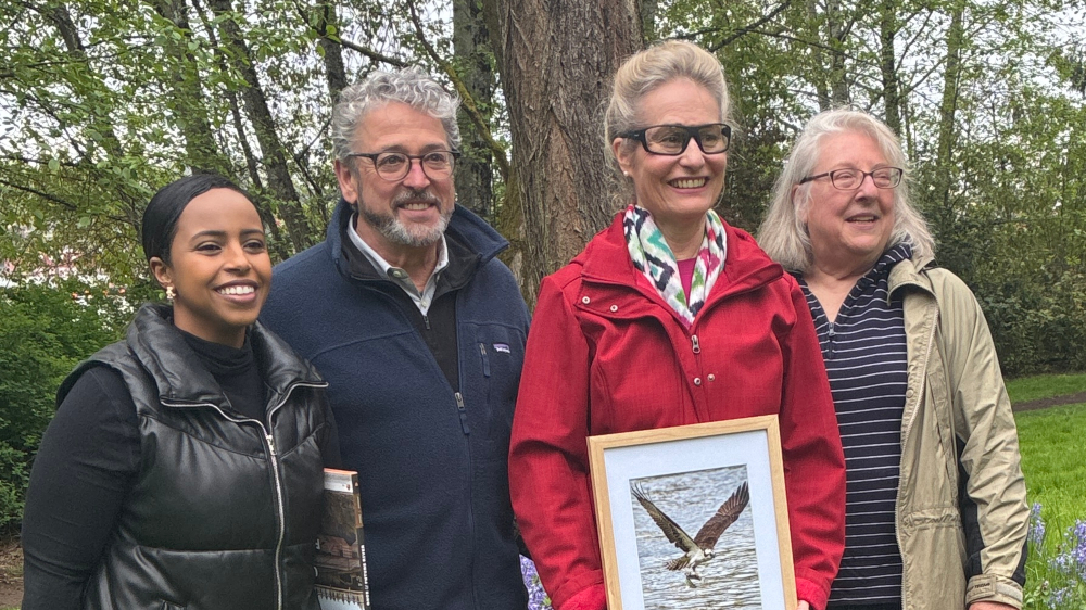 Katherine Lynch with a framed image of a sea hawk, alongside Commissioners Felleman and Mohamed and Cecile Hansen. 