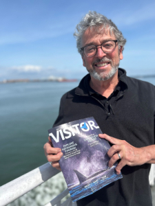 Commissioner Felleman holding the Visitors Guide.