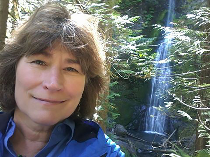 Cheryl O'Brien in front of a waterfall.