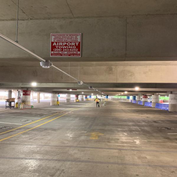 A construction worked installs the parking guidance system in the SEA airport arage.