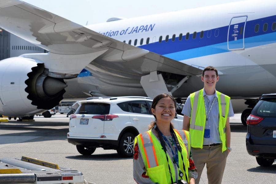 Interns in front of a jet.