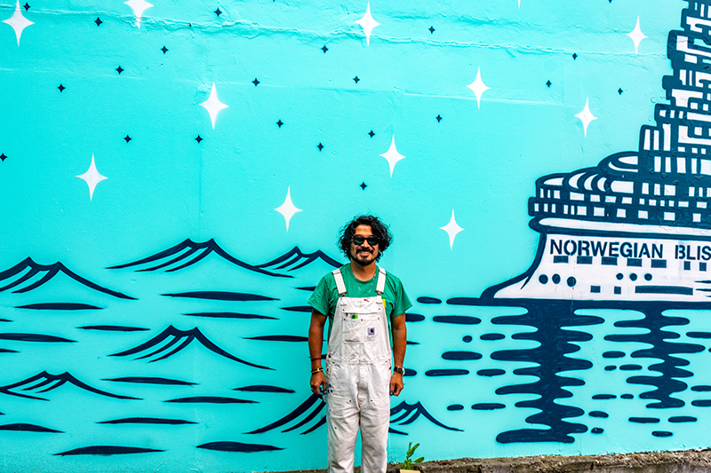 Artist Shogo Oto stands in front of his "Luna" mural
