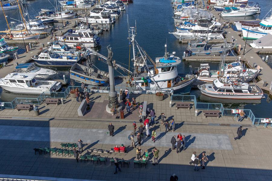 People gathered around the Seattle Fishermen's Memorial statue.