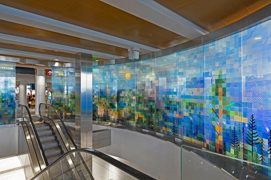A depiction of a forest made out of squares of green and blue glass.