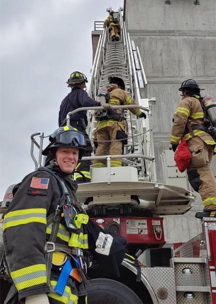 Commissioner Calkins waits as firefighters practice training drills.
