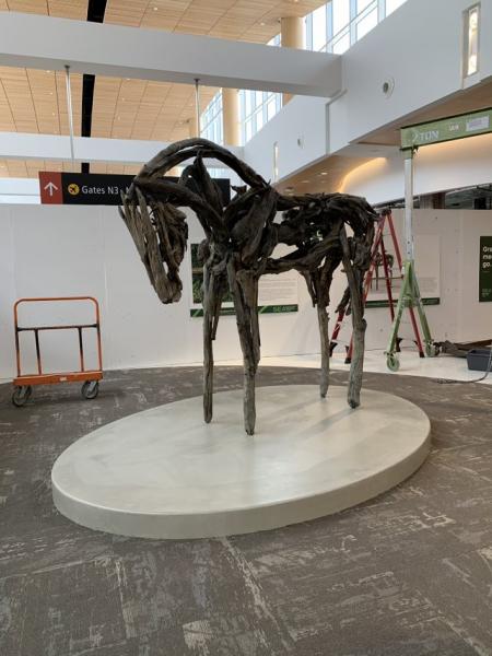 A minimalist horse sculpted out of natural material.