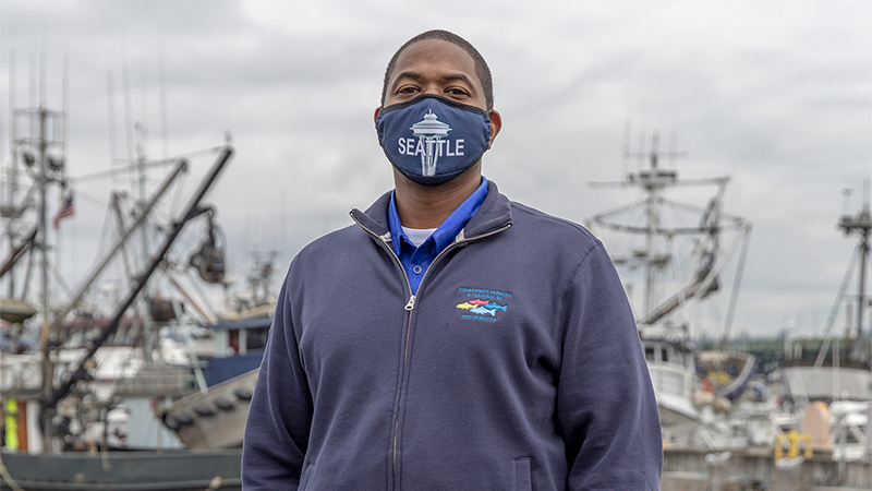 Port of Seattle Fishermen's Terminal employee with fishing fleet visible in the background.