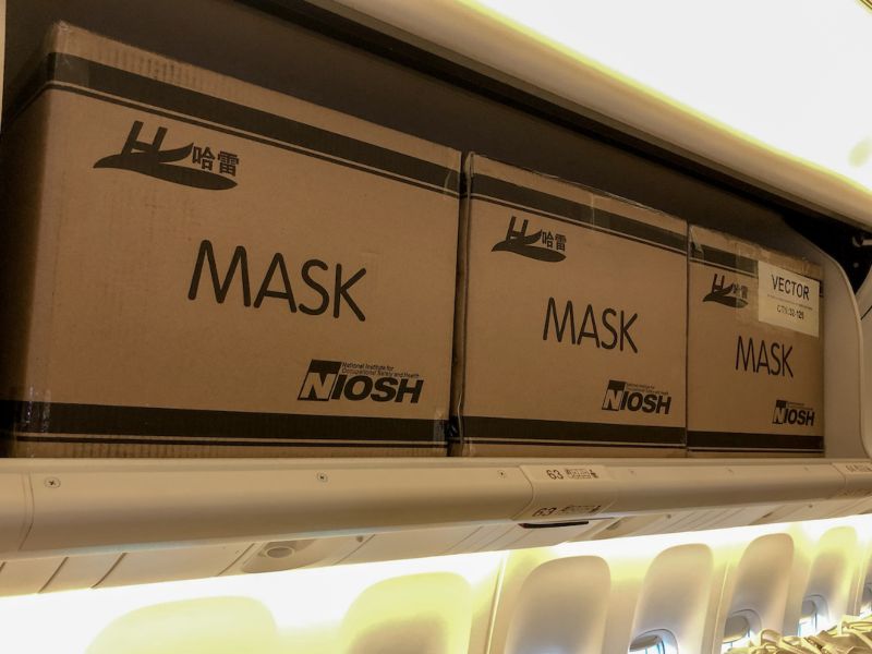 EVA Air carrying boxes of masks in passenger overheads and seats.