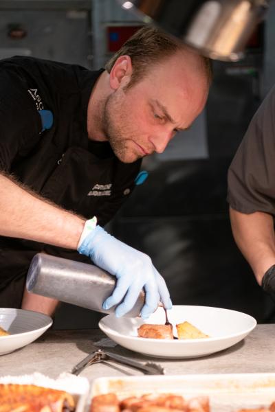 Chef Brandon Muehl prepares a dessert to serve.