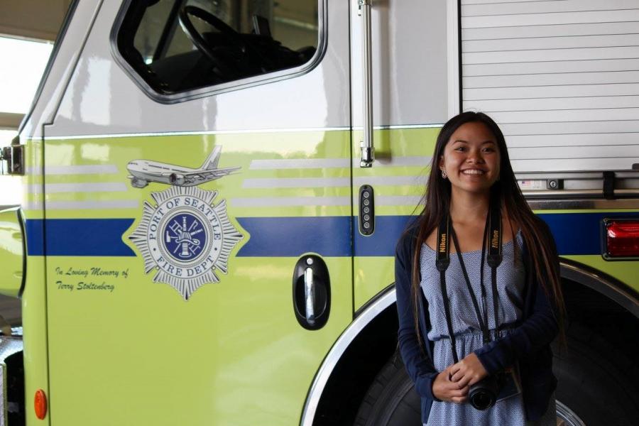 Bryanna Bui in front of a Port fire truck.