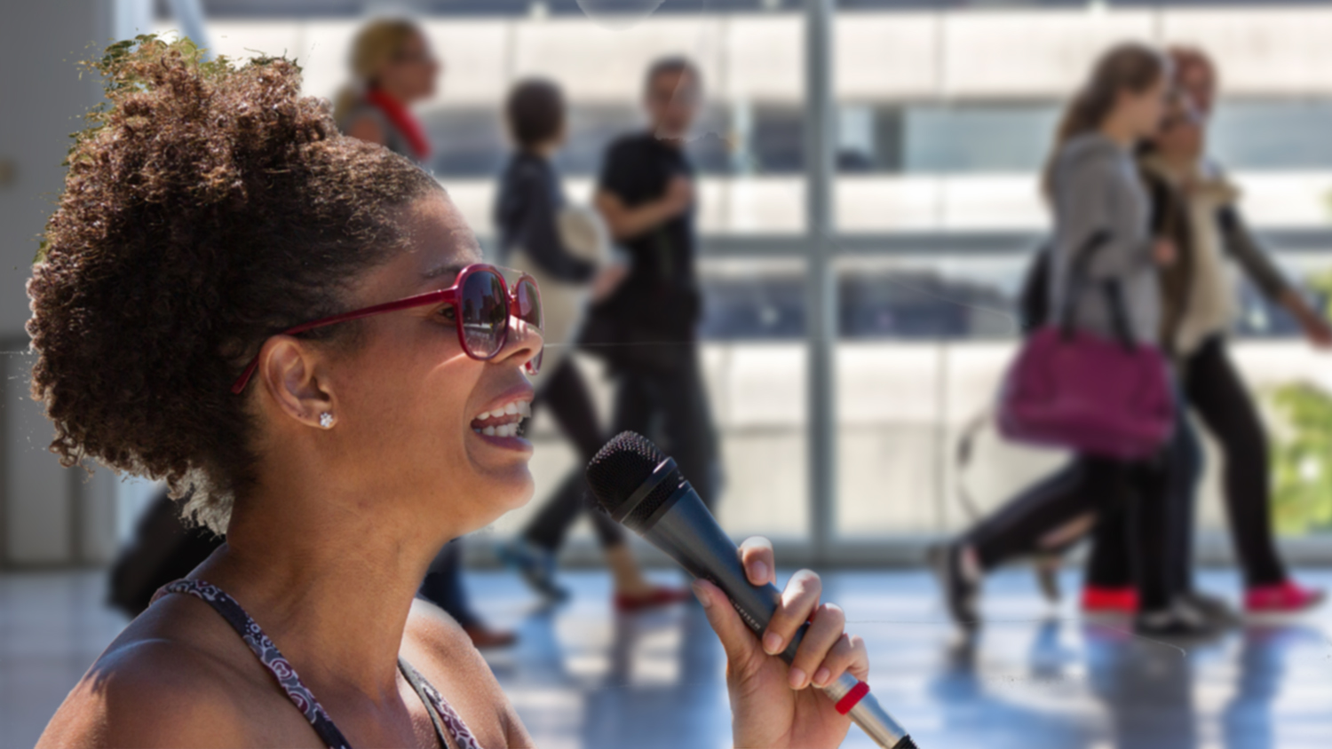 Woman exercising her First Amendment Rights at an airport by speaking into a microphone.
