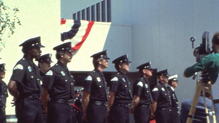 Officers standing lined up in a row for a ceremony.