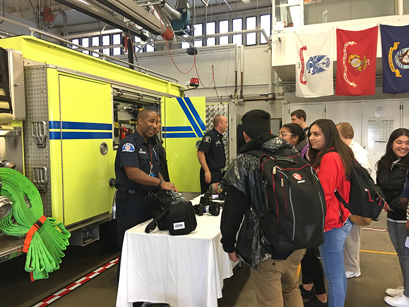 Port of Seattle Firefighters teaching youth about being a firefighter.