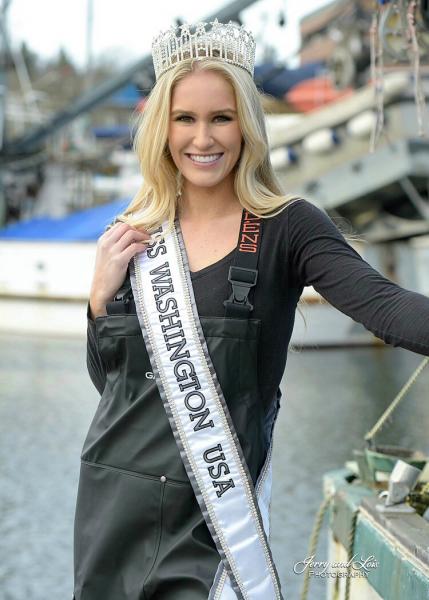 Evelyn Clark in fishing gear with crown on and Miss Washington USA sash on.