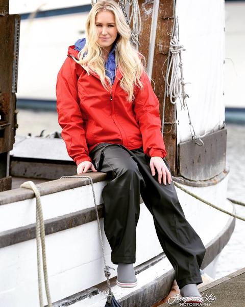 Evelyn Clark in fishing gear sitting on the side of a boat.