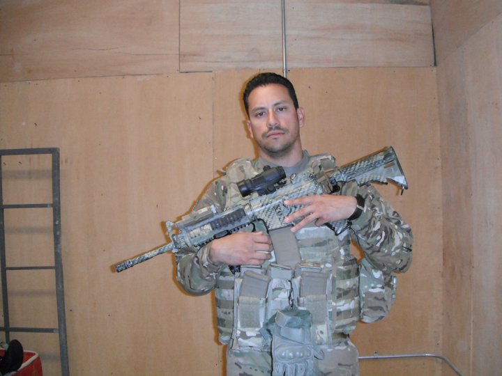 Juan Alvergue holding an automatic.
