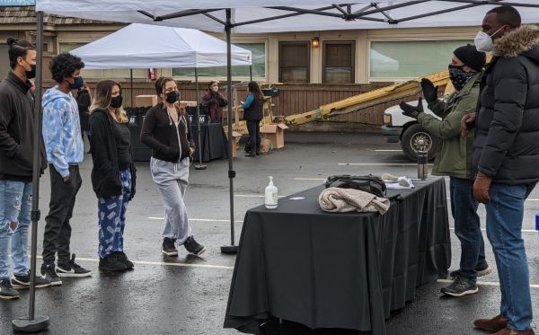 Students standing under a tent at a 2020 event.