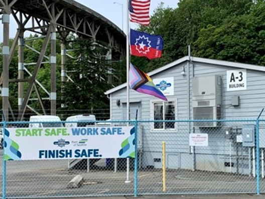 Junteenth and Pride flags fly over the Maritime Maintenance facility at Pier 91.
