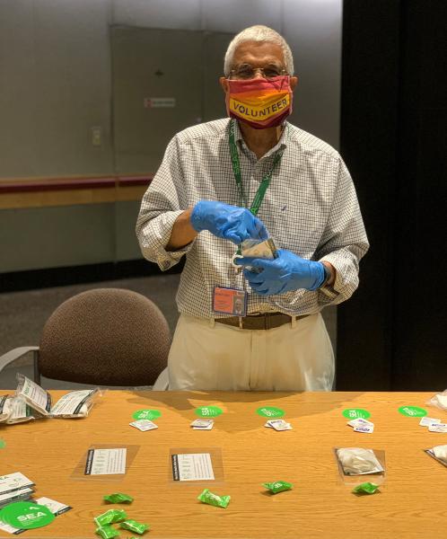 SEA volunteer Mohan puts together care kits.
