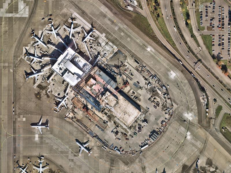 Aerial image of the North Satellite with the north end of the facility completed and in operation, and the south end under construction.