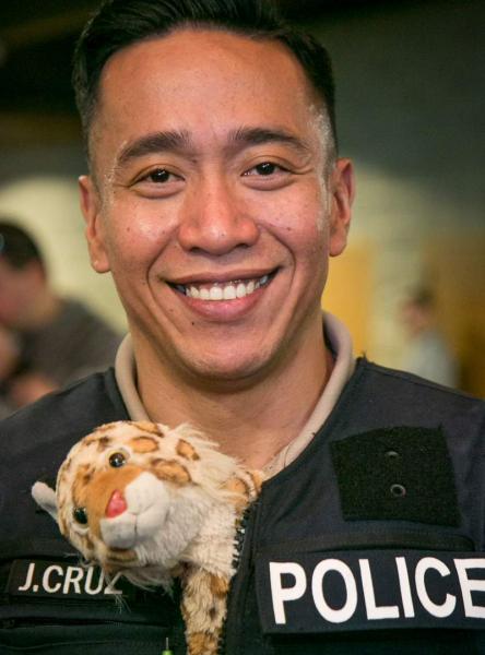 Port of Seattle Police officer and stuffed animal.