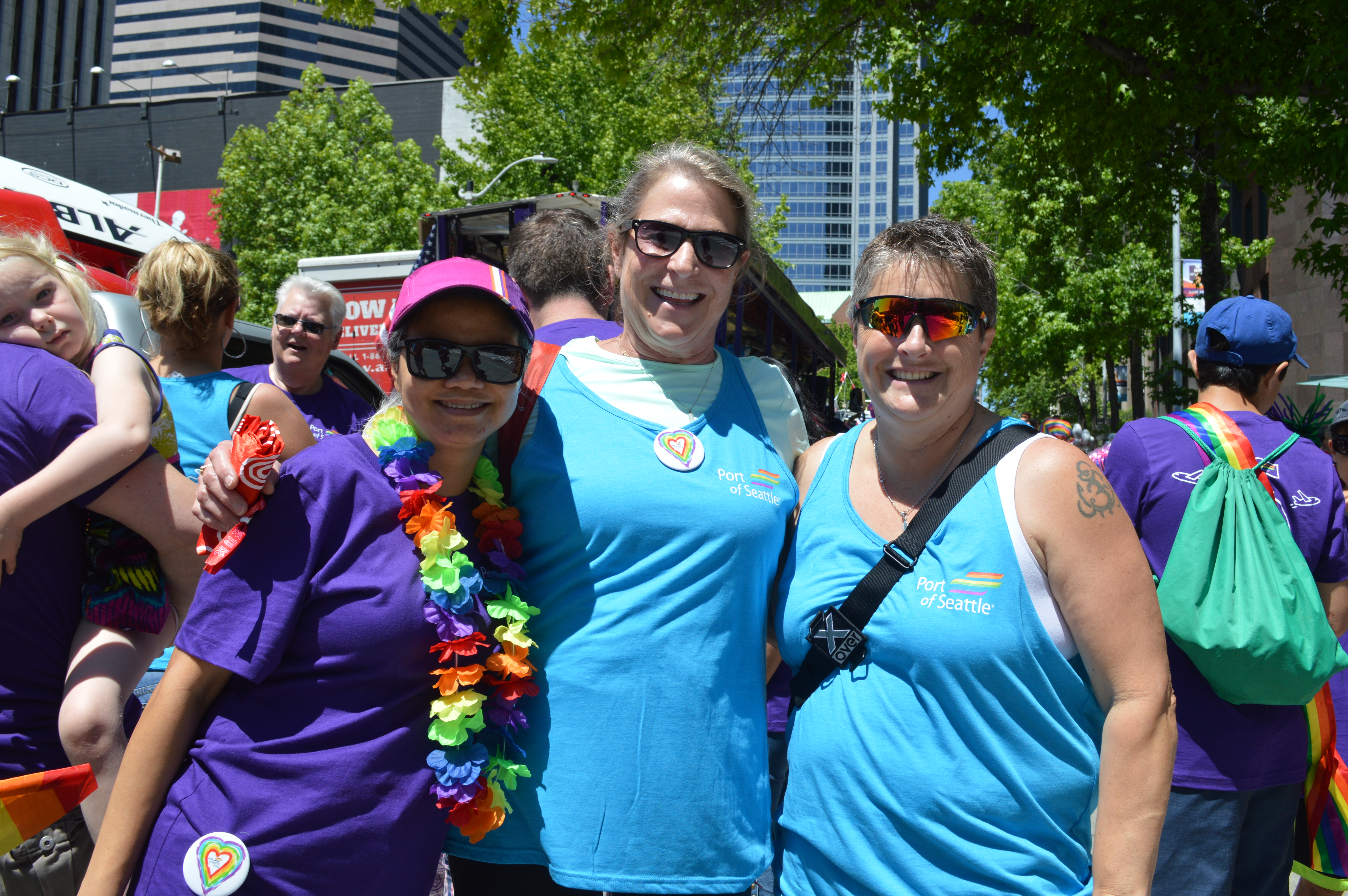 Elizabeth&nbsp;Leavitt marching in the 2018 Seattle Pride Parade, wearing sunglasses and holding a rainbow flag among other parade participants.