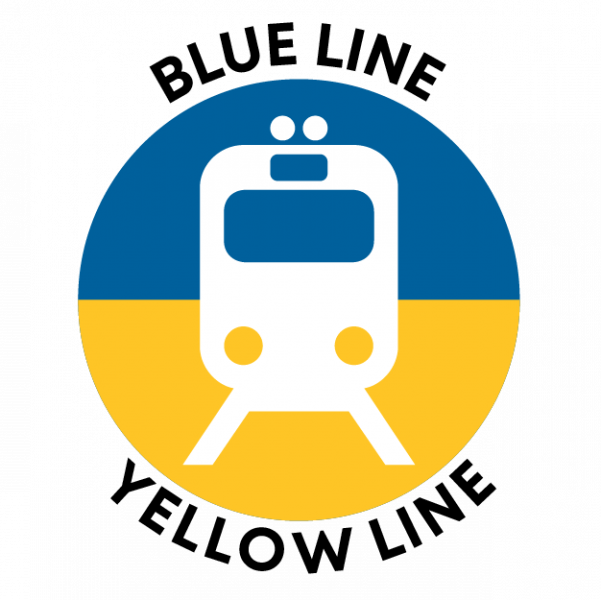 Circular icon divided horizontally into a blue upper half and yellow lower half, featuring a simplified white front‑view train symbol centered in the circle. The words ‘BLUE LINE’ appear curved above the icon and ‘YELLOW LINE’ curved below.