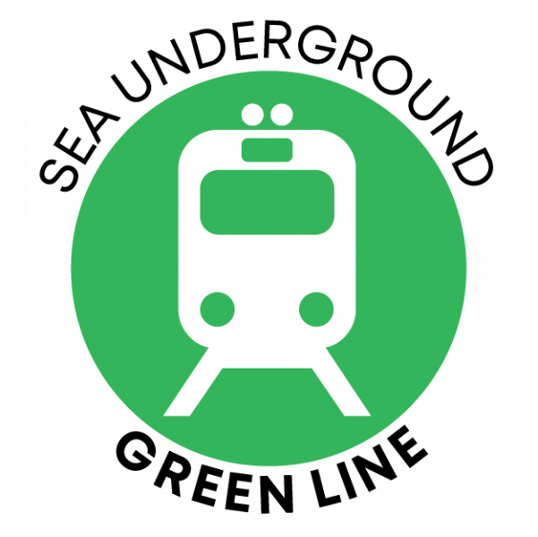 Circular green icon featuring a simplified white front‑view train symbol. The words ‘SEA UNDERGROUND’ curve above the circle and ‘GREEN LINE’ curve below.
