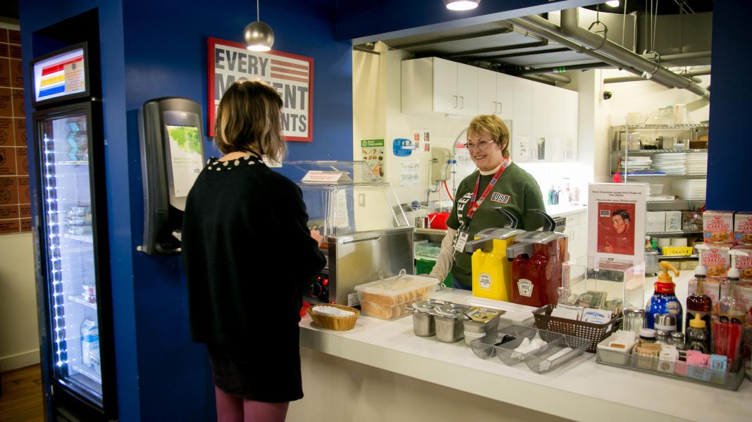 Jeanne working at the USO food stand, tending to a customer.