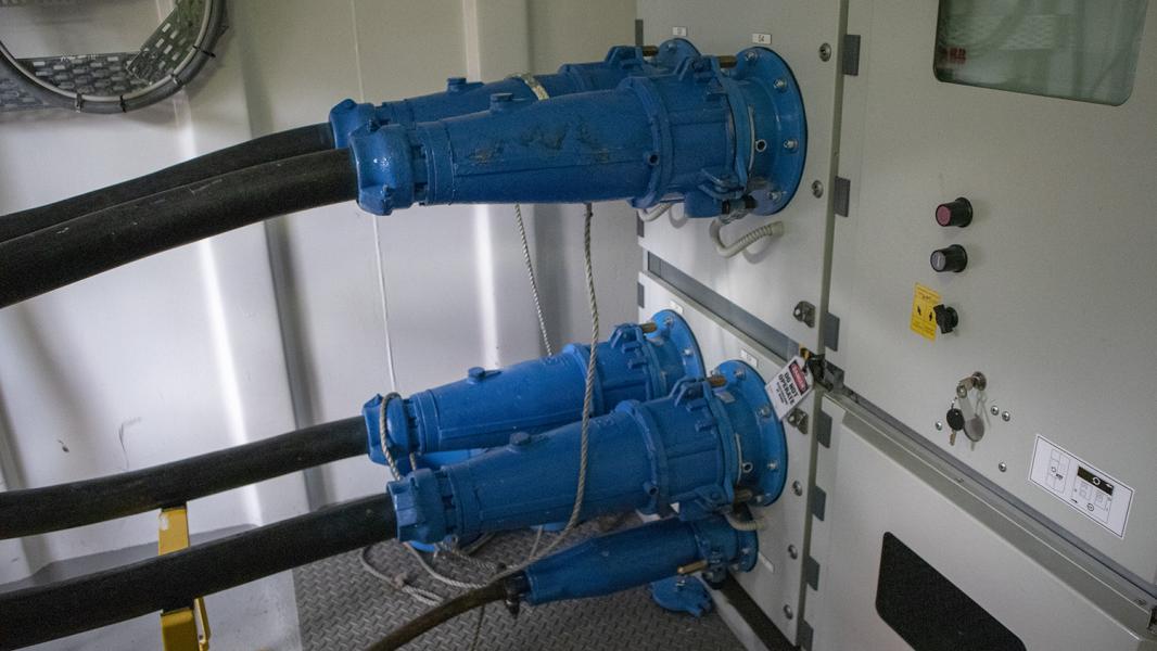 Two large electrical plugs plugged into a cruise ship called shore power.