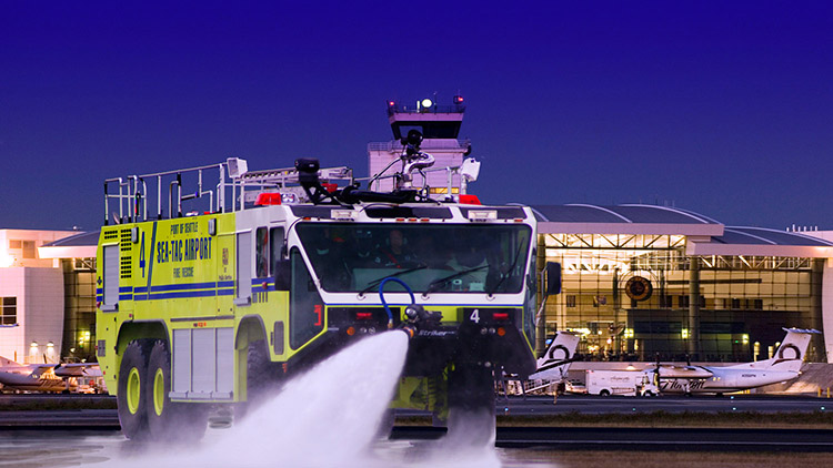 ARFF Truck blasting water from a hose.