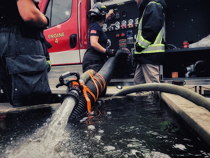 Port of Seattle firefighters with a water hose.
