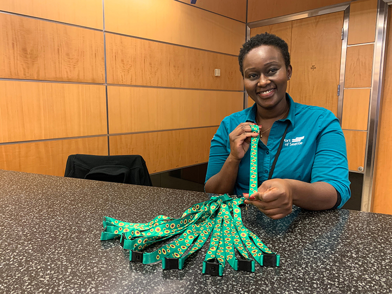 Employee holding a bundle of sunflower lanyards.