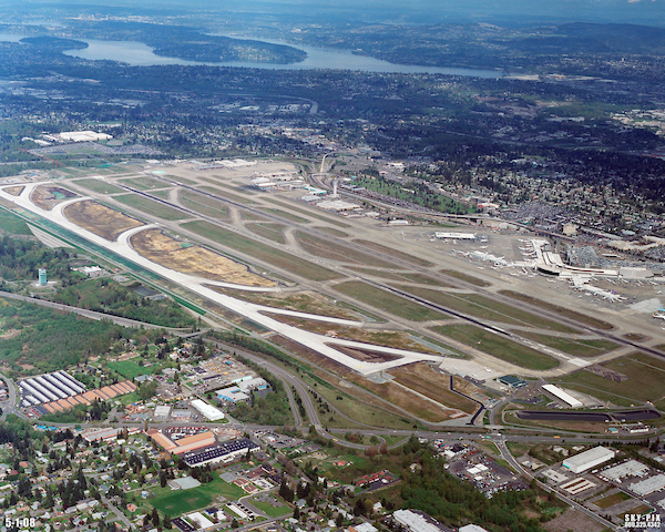 Aerial image showing an airport with parallel runways, taxiways, and terminal areas.