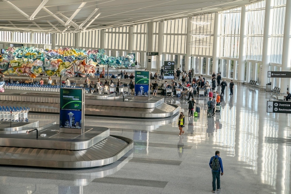Baggage claim in the IAF Grand Hall at SEA Airport.