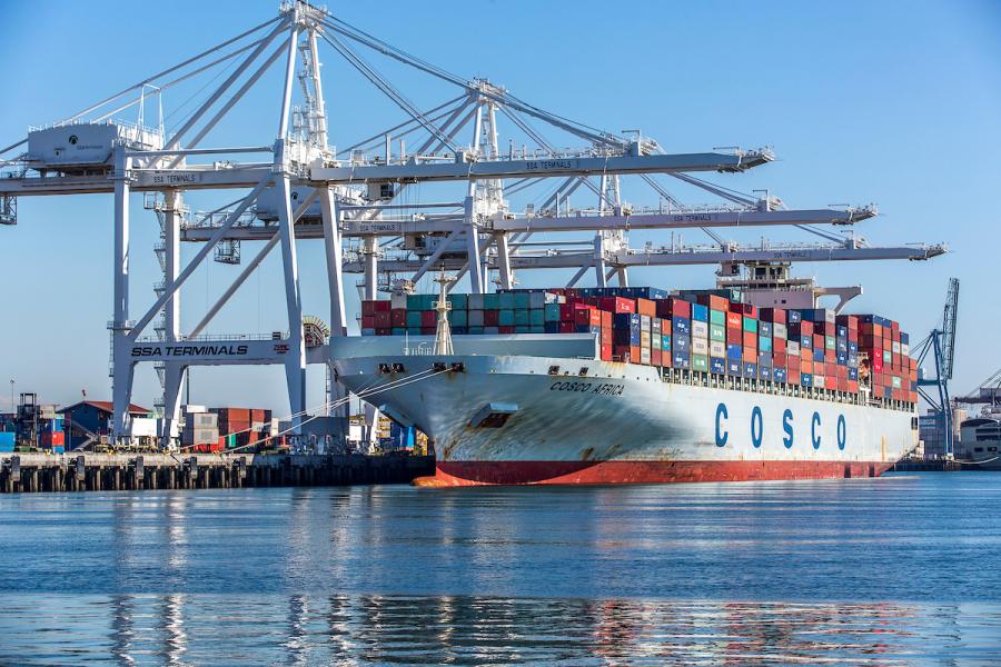 Commercial ship picking up containers.