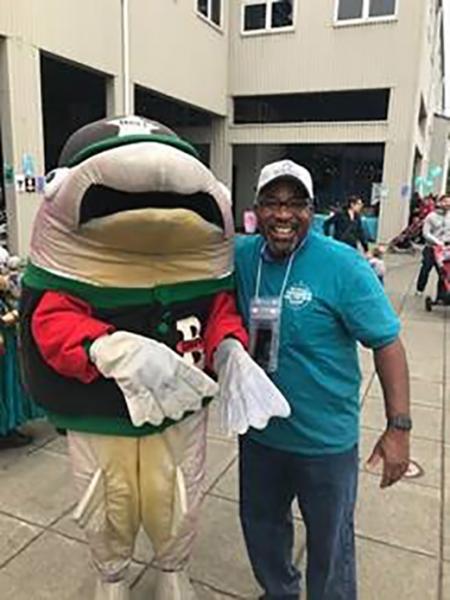 Delmas Whittaker with a fish mascot.