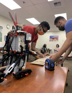 Students working with a robot.