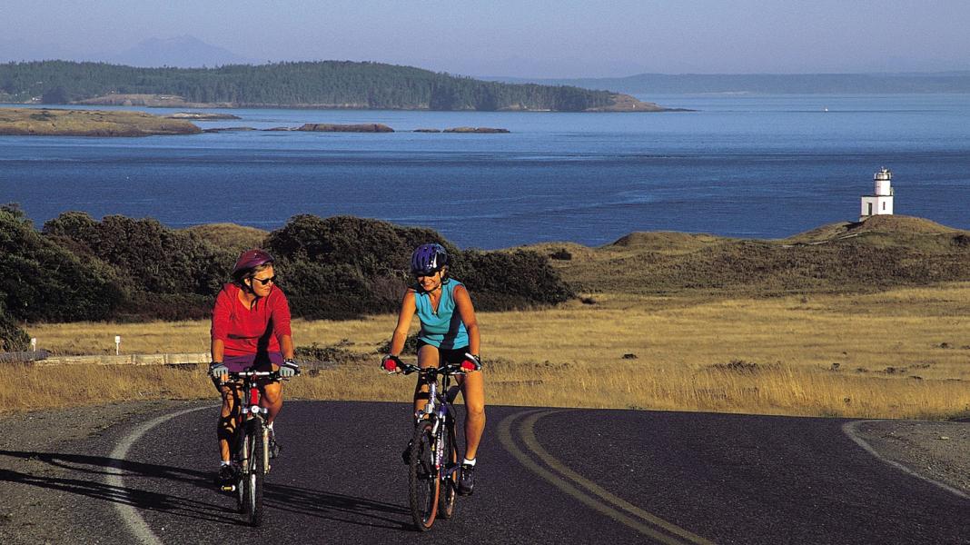 Two women bicycle on Whidbey Island.
